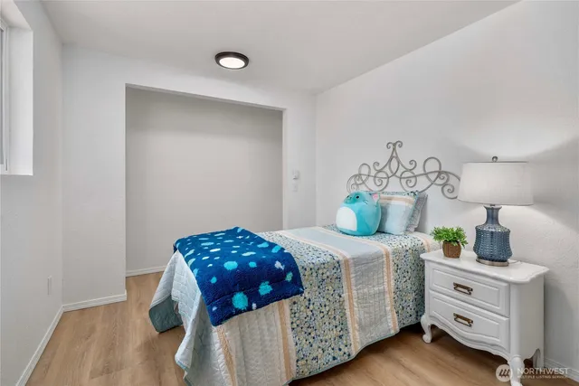 a bedroom with a bed and a dresser in it