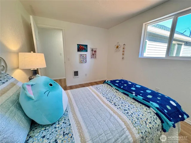a bedroom with a bed and a chair