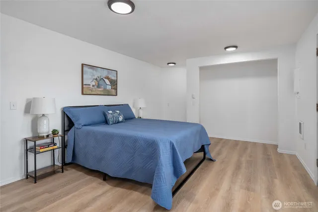 a bedroom with a bed and a lamp