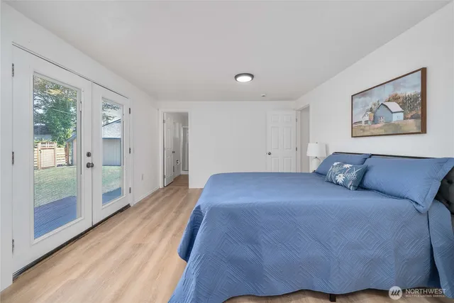 a bedroom with a bed and glass doors