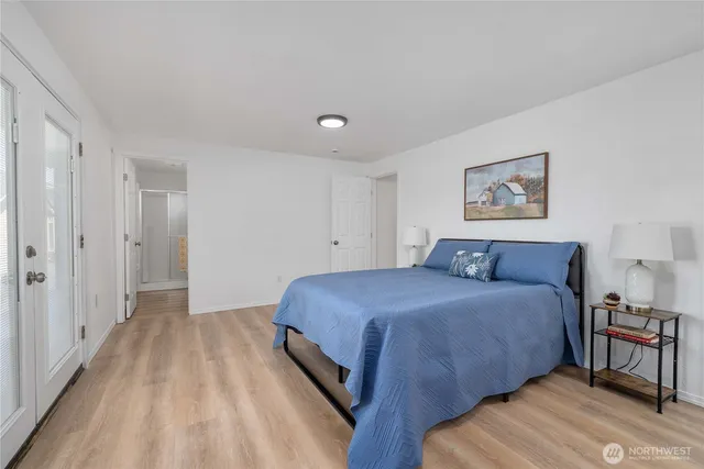 a spacious bedroom with a bed and a table