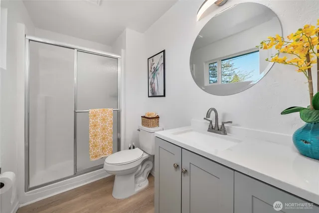 a bathroom with a toilet a sink and a mirror