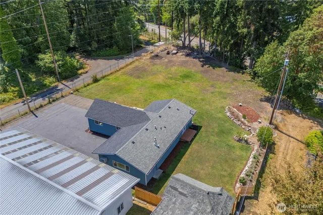 an aerial view of a house with garden space and street view
