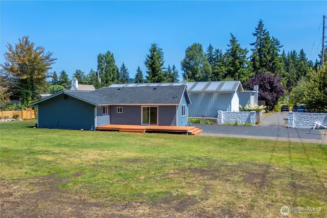 a view of a house with pool and a yard