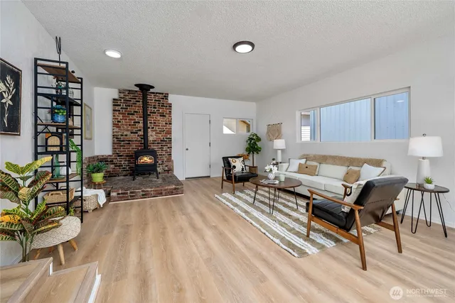 a living room with furniture a couch and potted plant