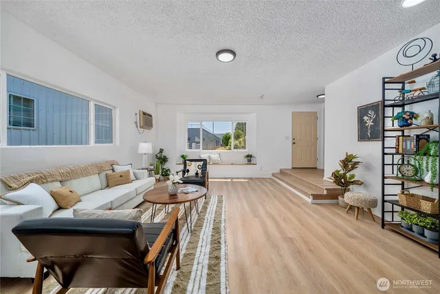 a living room with furniture and bookshelf