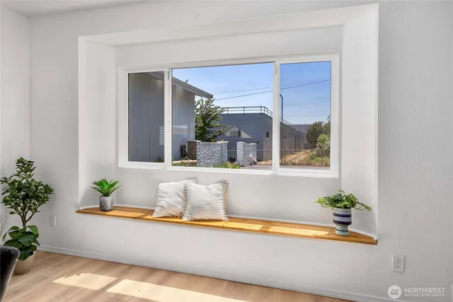 a white bath tub sitting in a bathroom next to a window