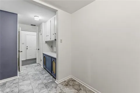 a hallway with a washer and dryer
