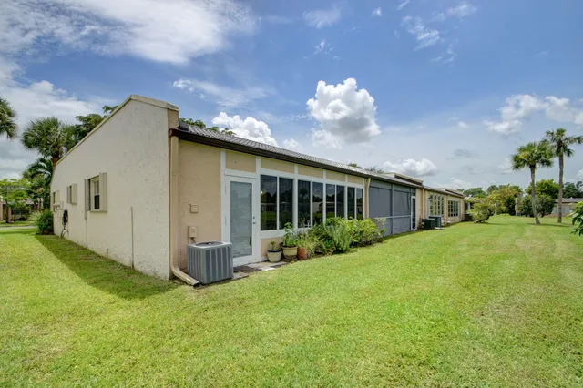 a view of a fountain in front of a house with a yard