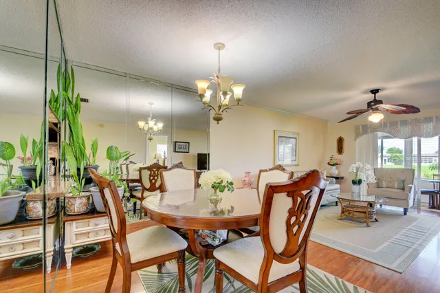 a view of a dining room with furniture and chandelier