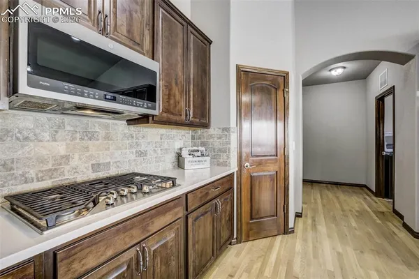 a kitchen with stainless steel appliances granite countertop a stove a refrigerator and a microwave