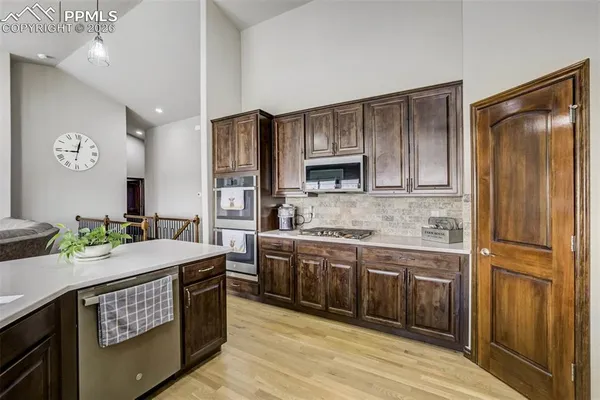 a kitchen with kitchen island granite countertop a sink stove and refrigerator