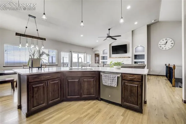 a kitchen with stainless steel appliances granite countertop wooden cabinets a sink and a stove