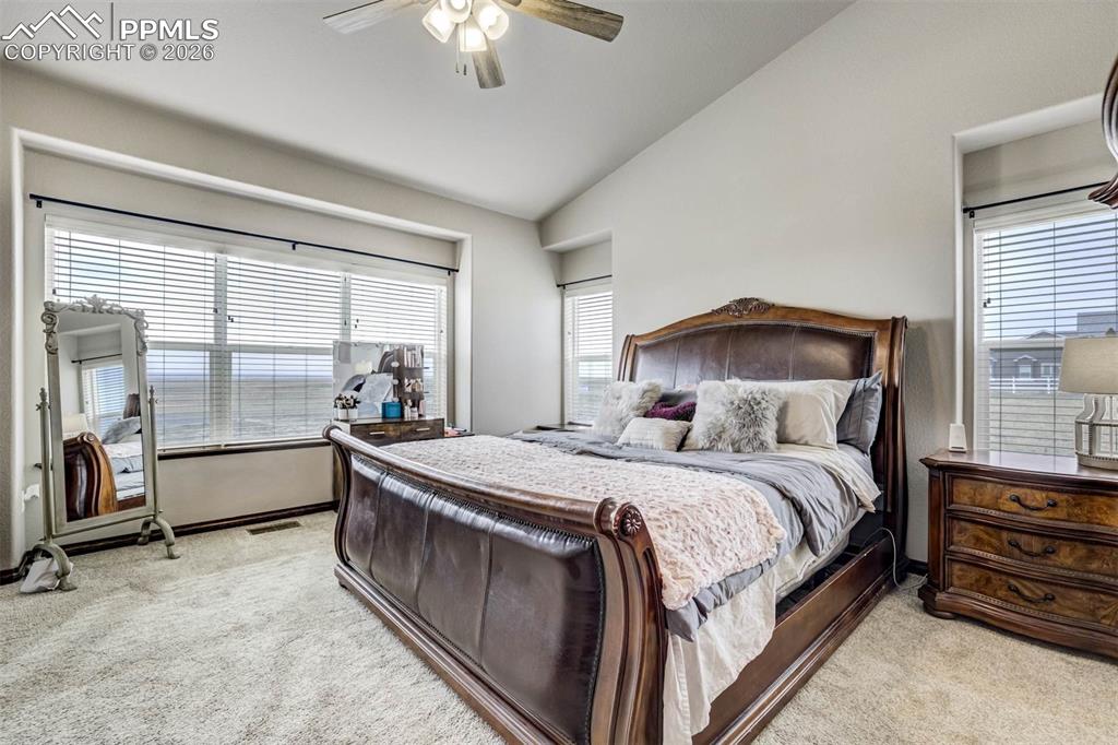 12095 Silver Concho Trail Elbert, CO 80106 - Photo 16 of 38 a bed room with a bed and a chandelier