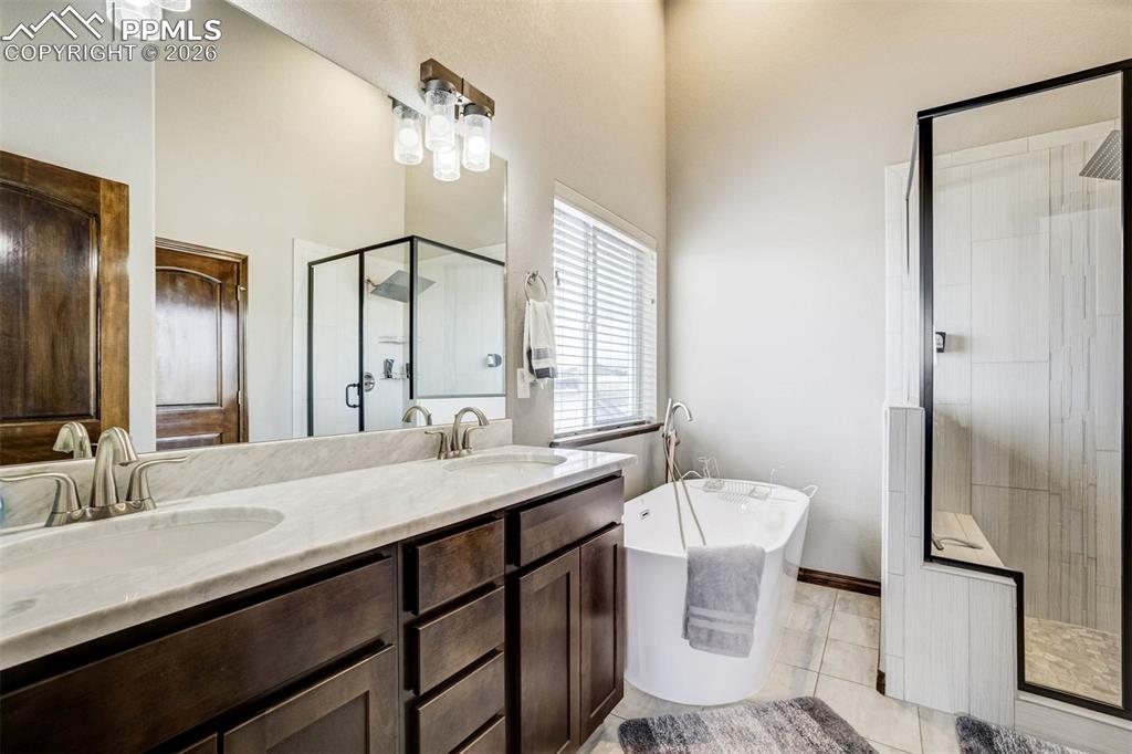 12095 Silver Concho Trail Elbert, CO 80106 - Photo 18 of 38 a bathroom with a sink a toilet and mirror