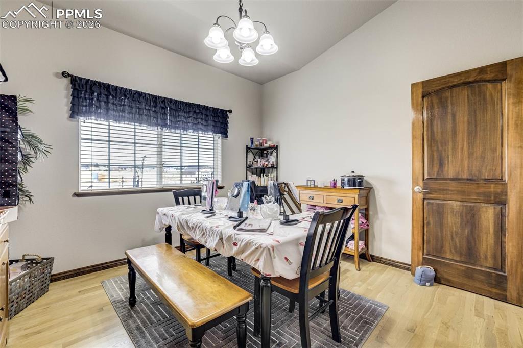 12095 Silver Concho Trail Elbert, CO 80106 - Photo 21 of 38 a view of a dining room with furniture and a chandelier