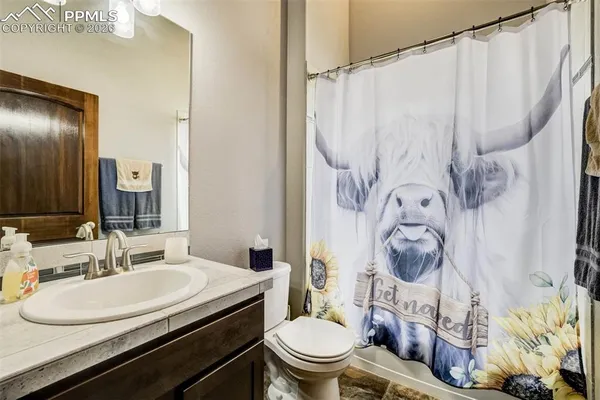 a bathroom with a sink a toilet and a mirror