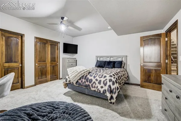 a bedroom with a bed and a television