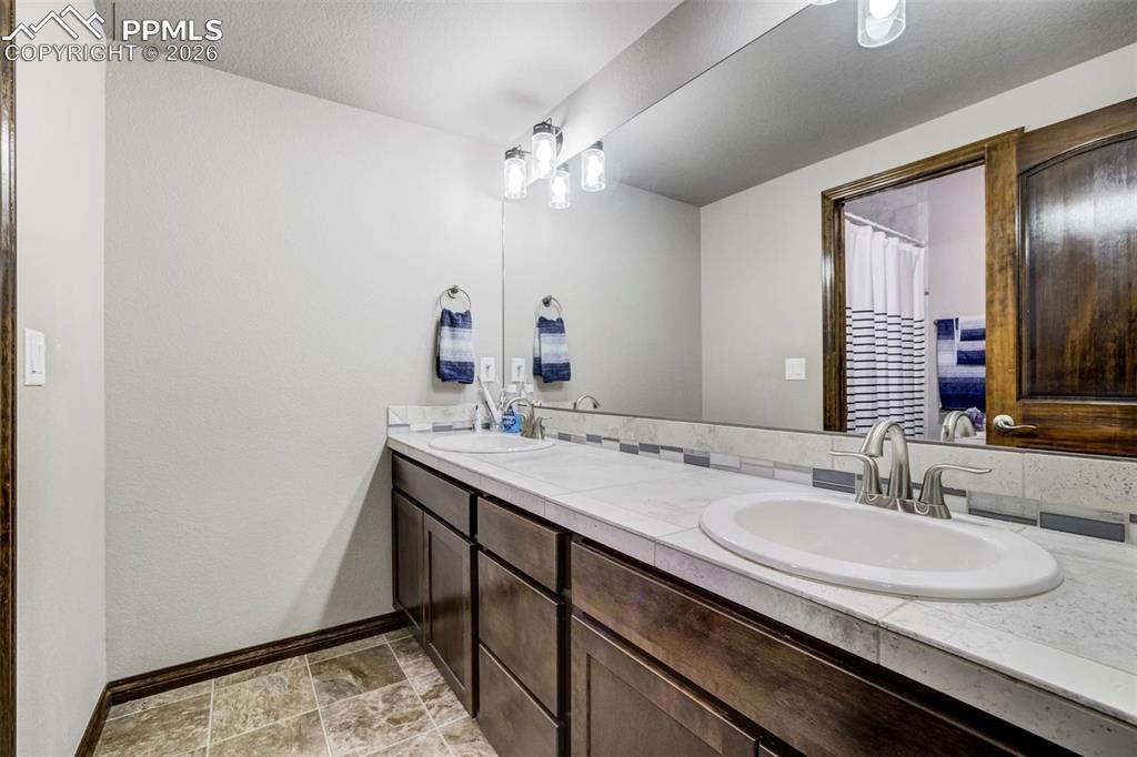 12095 Silver Concho Trail Elbert, CO 80106 - Photo 31 of 38 a bathroom with a sink and a mirror