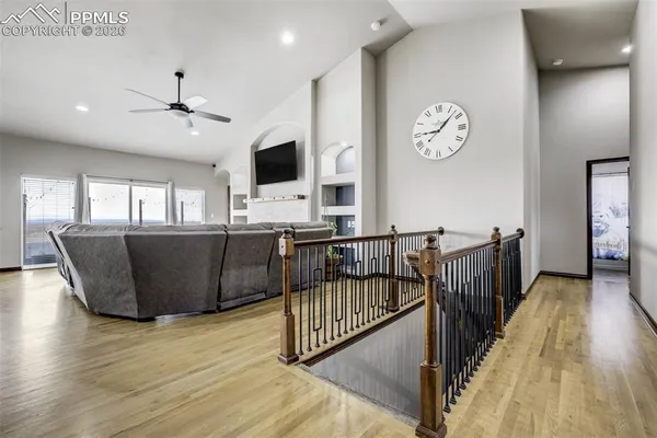 a view of a kitchen with wooden floor and a flat screen tv
