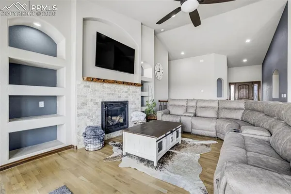 a living room with furniture and a fireplace
