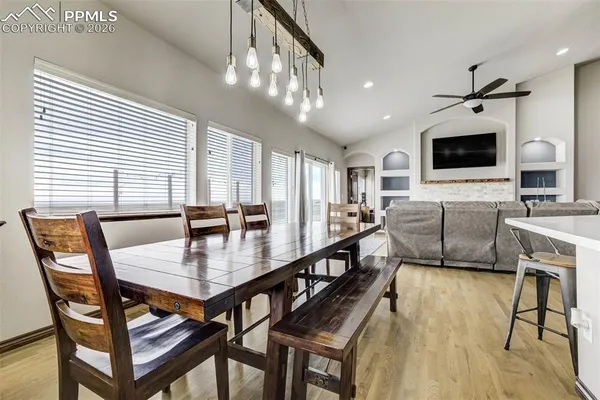 a view of a dining room with furniture and a flat screen tv