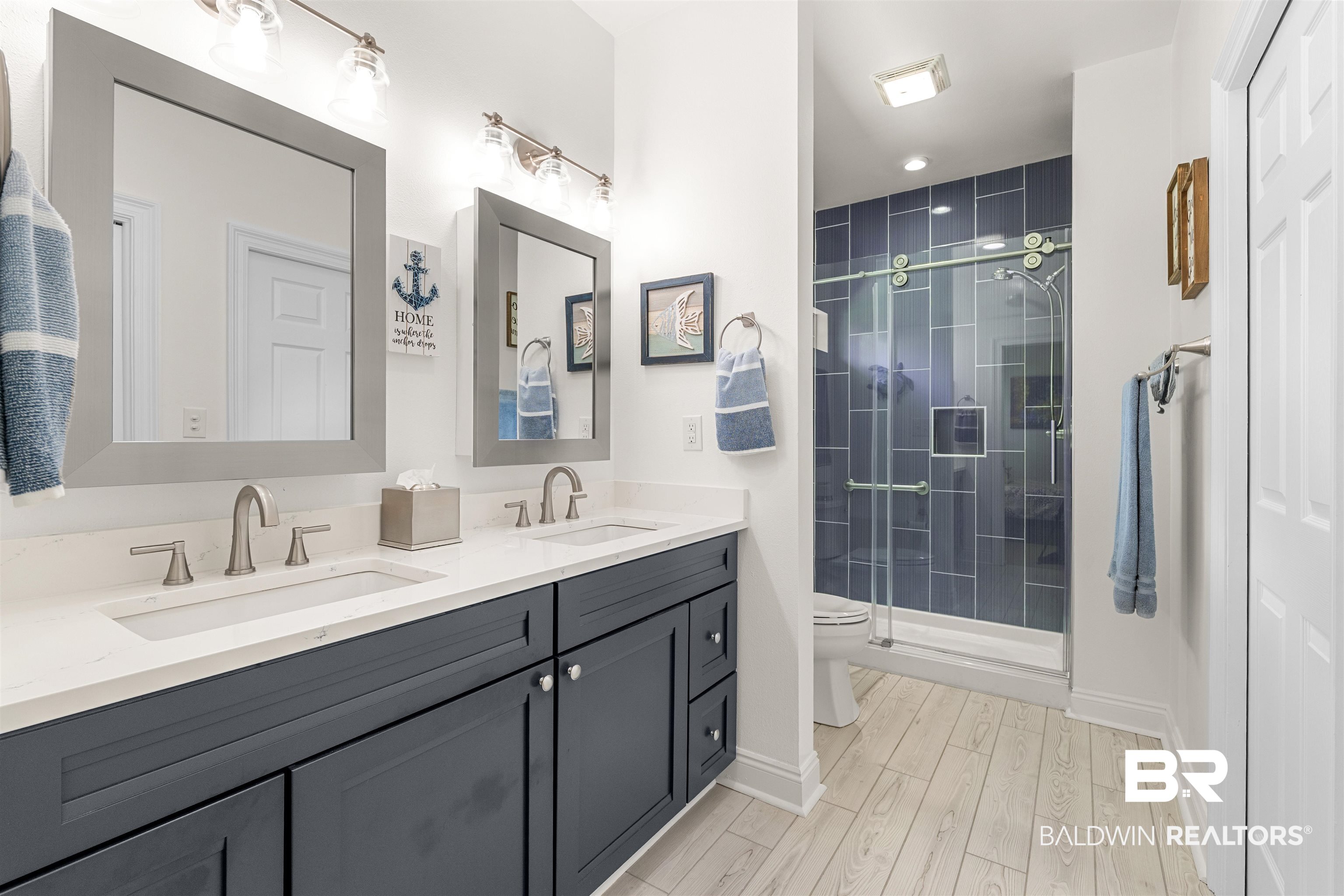 141 Mark Twain Loop Foley, AL 36535 - Photo 19 of 55 Full bath with double vanity, a stall shower, and wood finished floors