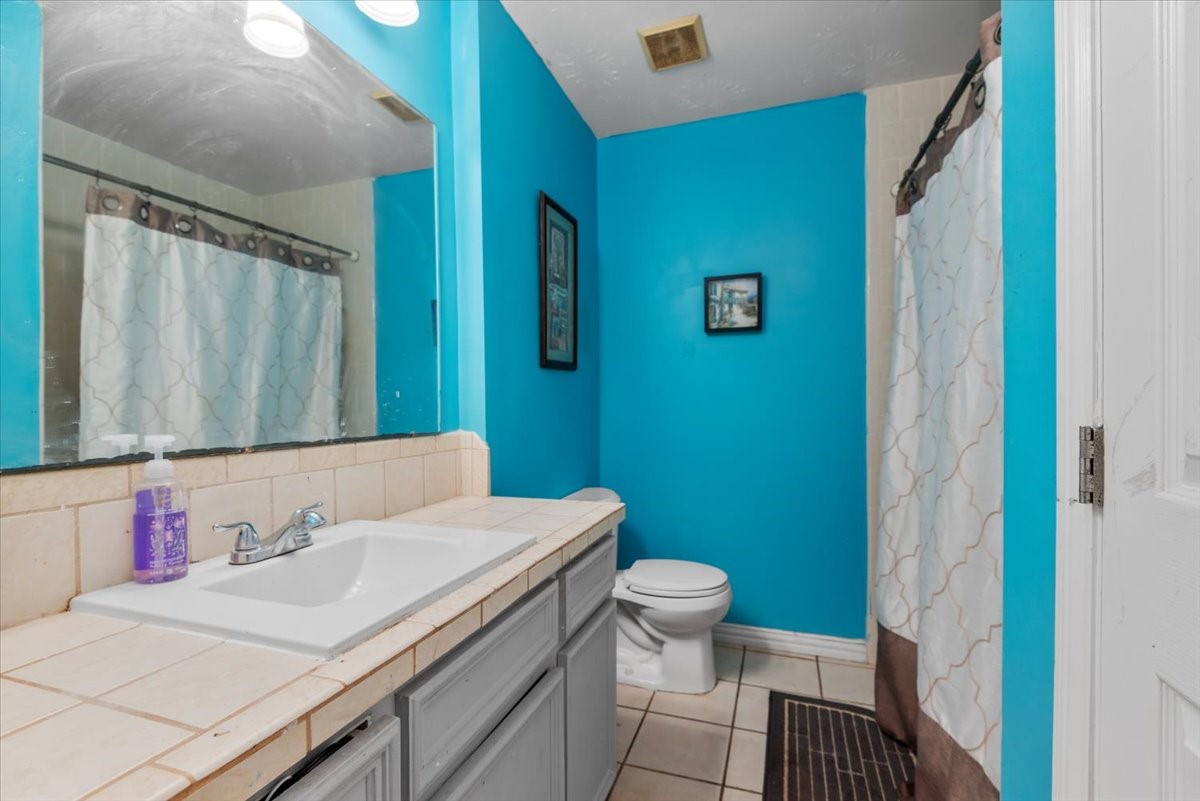 23011 Bayleaf Drive Spring, TX 77373 - Photo 15 of 22 a bathroom with a sink a toilet and a mirror