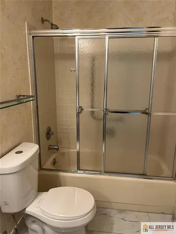 a white toilet sitting next to a bathroom sink