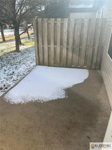 a view of a yard with wooden fence