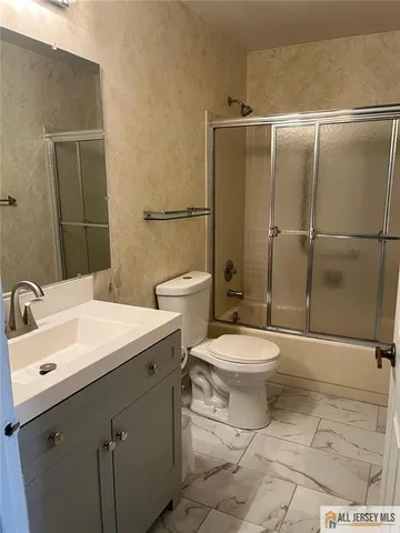 a bathroom with a toilet sink and shower