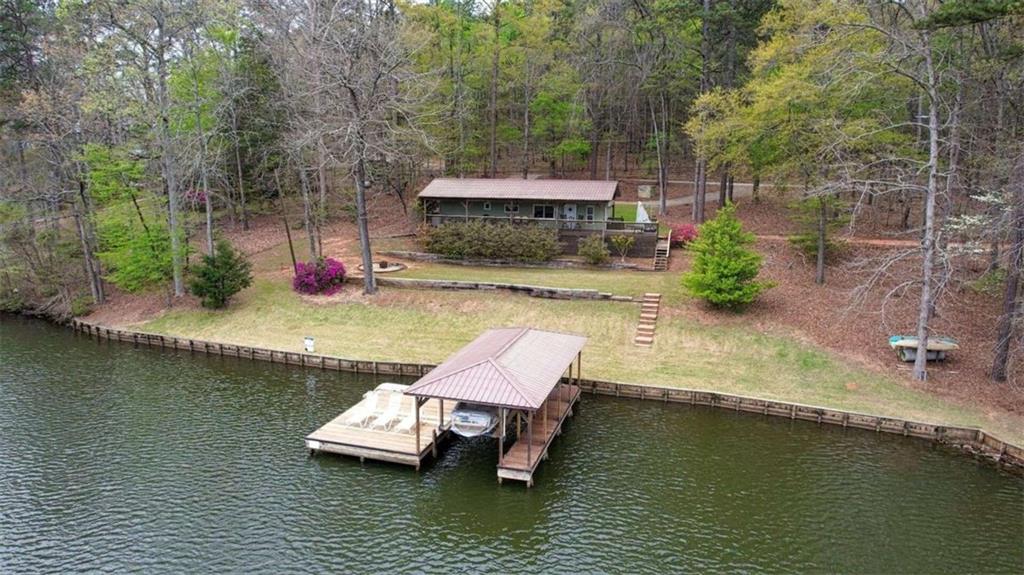 123 Copper Lane Mansfield, GA 30055 - Photo 12 of 43 an aerial view of a house with swimming pool and lake view