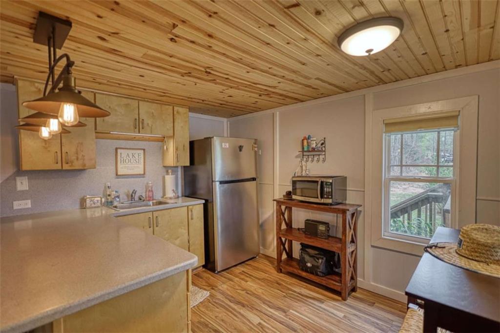 123 Copper Lane Mansfield, GA 30055 - Photo 19 of 43 a kitchen with refrigerator cabinets and wooden floor