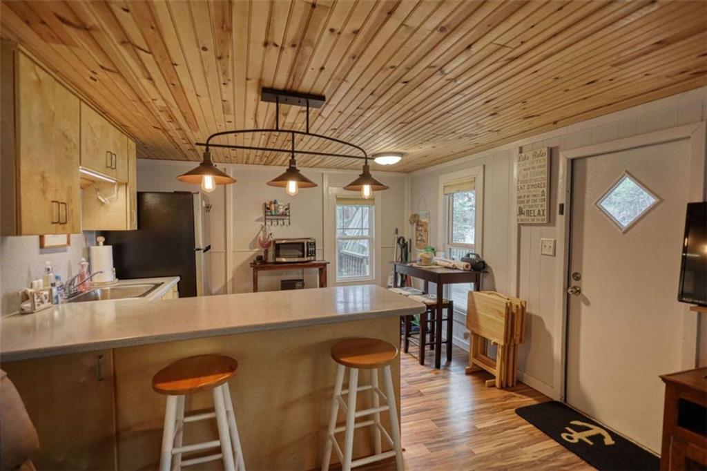 123 Copper Lane Mansfield, GA 30055 - Photo 22 of 43 a kitchen with stainless steel appliances granite countertop a dining table chairs sink and wooden floor