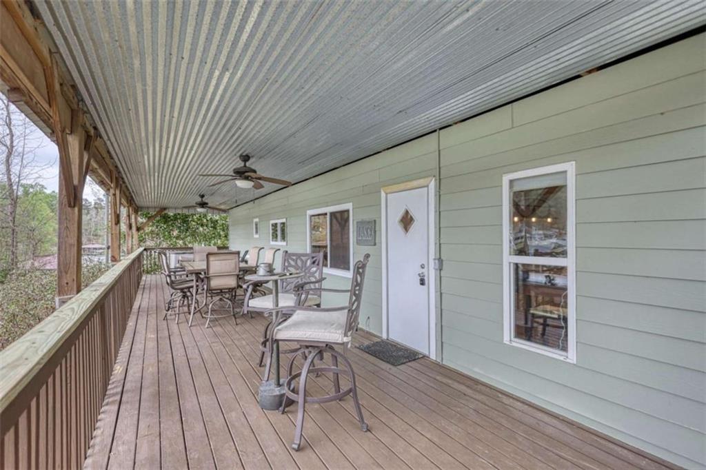 123 Copper Lane Mansfield, GA 30055 - Photo 33 of 43 a view of a patio with table and chairs with wooden floor and fence