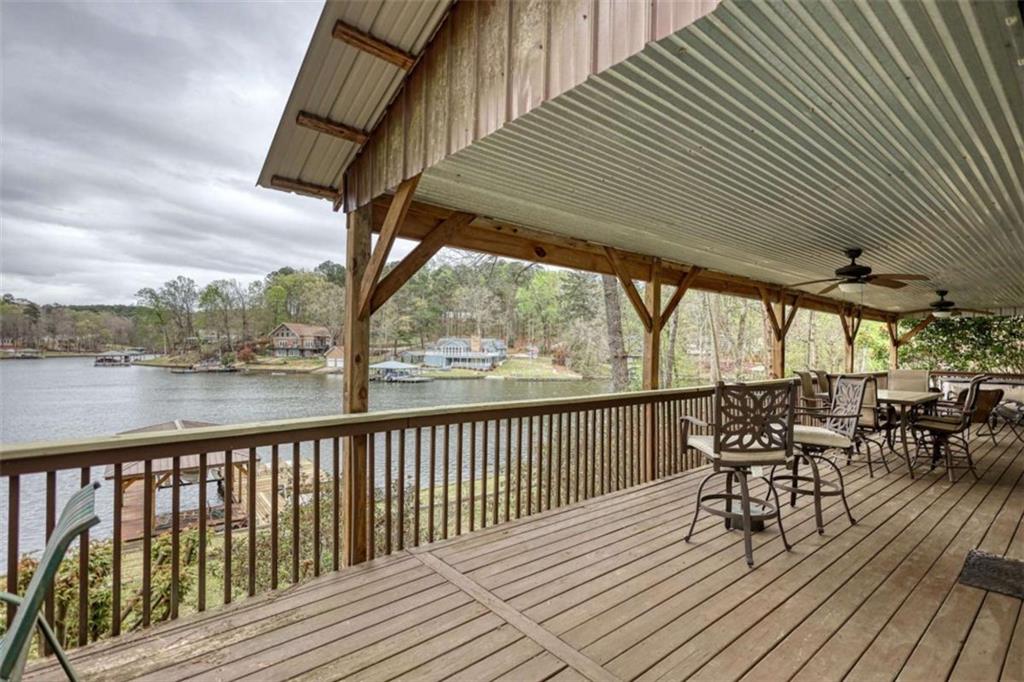 123 Copper Lane Mansfield, GA 30055 - Photo 34 of 43 a view of a balcony with chairs and wooden floor