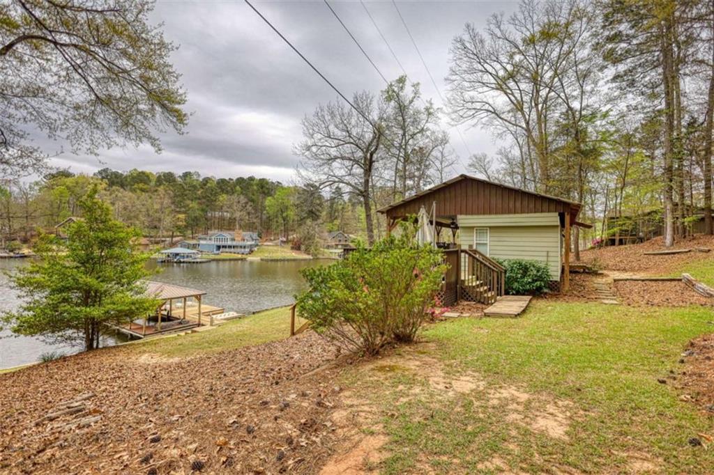 123 Copper Lane Mansfield, GA 30055 - Photo 4 of 43 a front view of a house with a yard and lake view