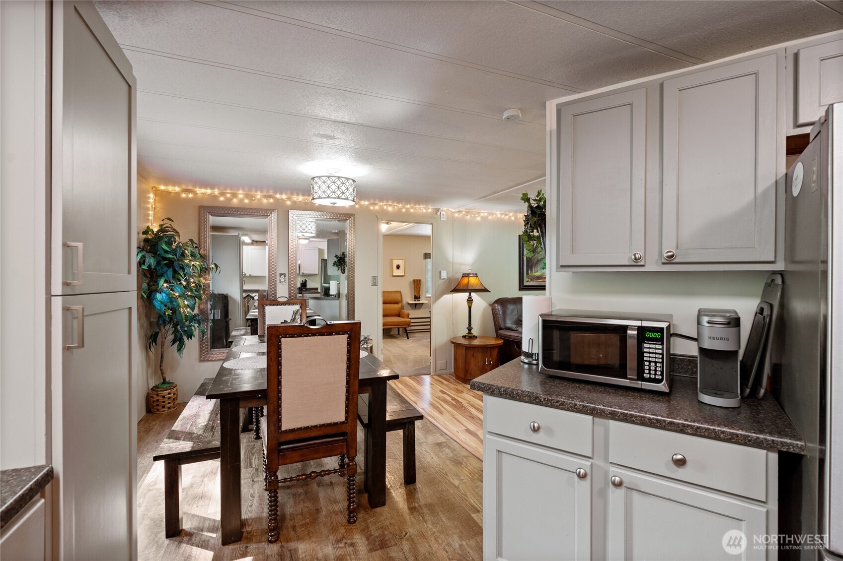 271 Skate Creek Road North Ashford, WA 98304 - Photo 9 of 40 a kitchen with a table chairs refrigerator and cabinets