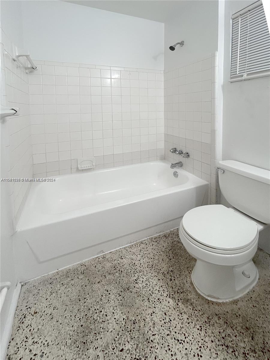 699 Northeast 86th Street, Unit 2 Miami, FL 33138 - Photo 11 of 12 a bathroom with a toilet a sink and bathtub