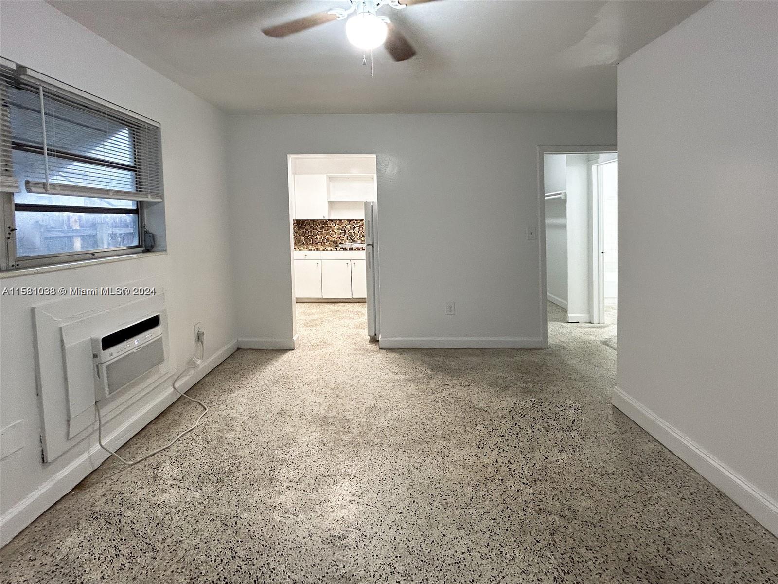 699 Northeast 86th Street, Unit 2 Miami, FL 33138 - Photo 4 of 12 an empty room with windows