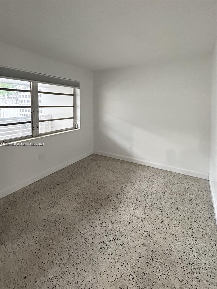 699 Northeast 86th Street, Unit 2 Miami, FL 33138 - Photo 6 of 12 an empty room with a window