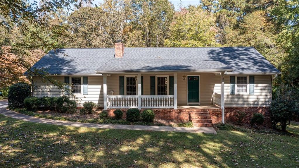 3300 East Fairview Road Southwest Stockbridge, GA 30281 - Photo 1 of 1 a front view of a house with a garden and porch