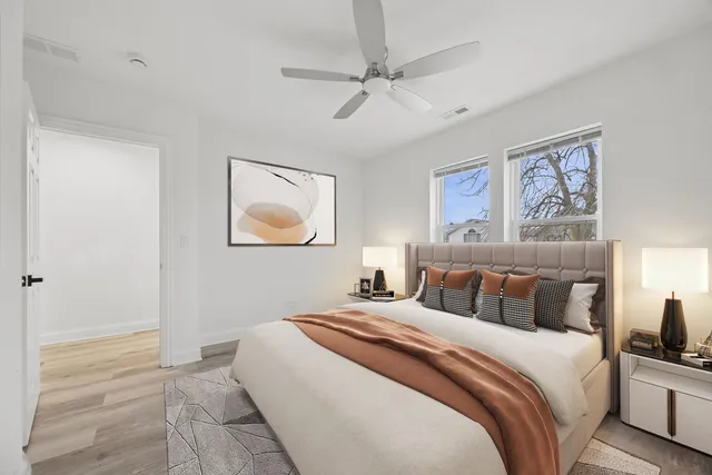 a bedroom with bed and painting on the wall