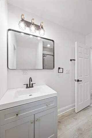 a bathroom with a sink and a mirror