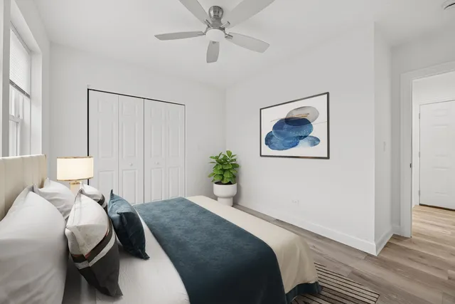 a bedroom with a bed and a painting on the wall