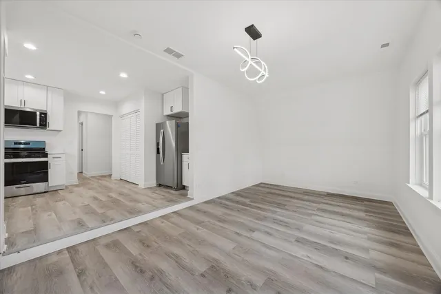 a view of a kitchen with a sink and a refrigerator