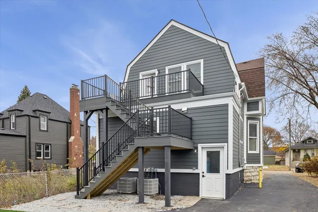 a front view of a house with a street