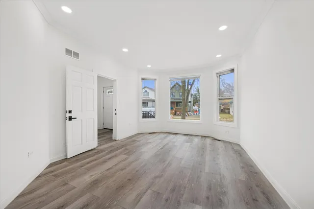 wooden floor in an empty room with a window