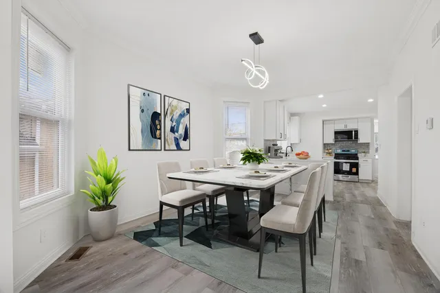 a view of a dining room with furniture and wooden floor