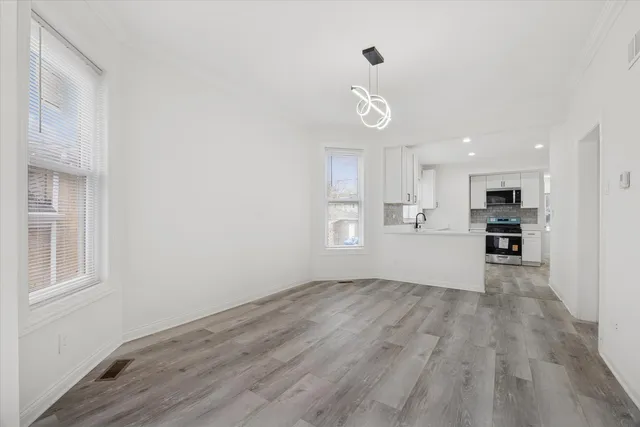 a view of kitchen with refrigerator and window